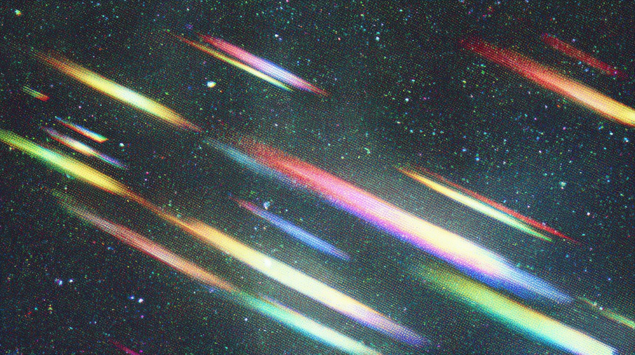 Multiple colorful light streaks resembling meteors cutting diagonally across a dark, star-speckled sky