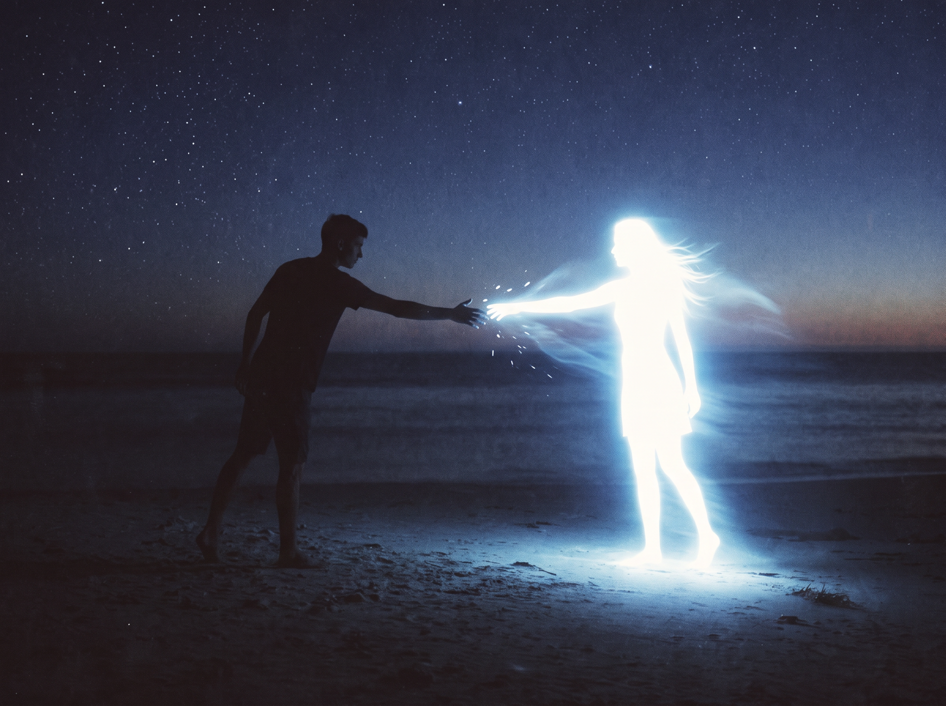 Silhouetted man reaching toward a glowing, ghost-like female figure on a beach at night under a starry sky.