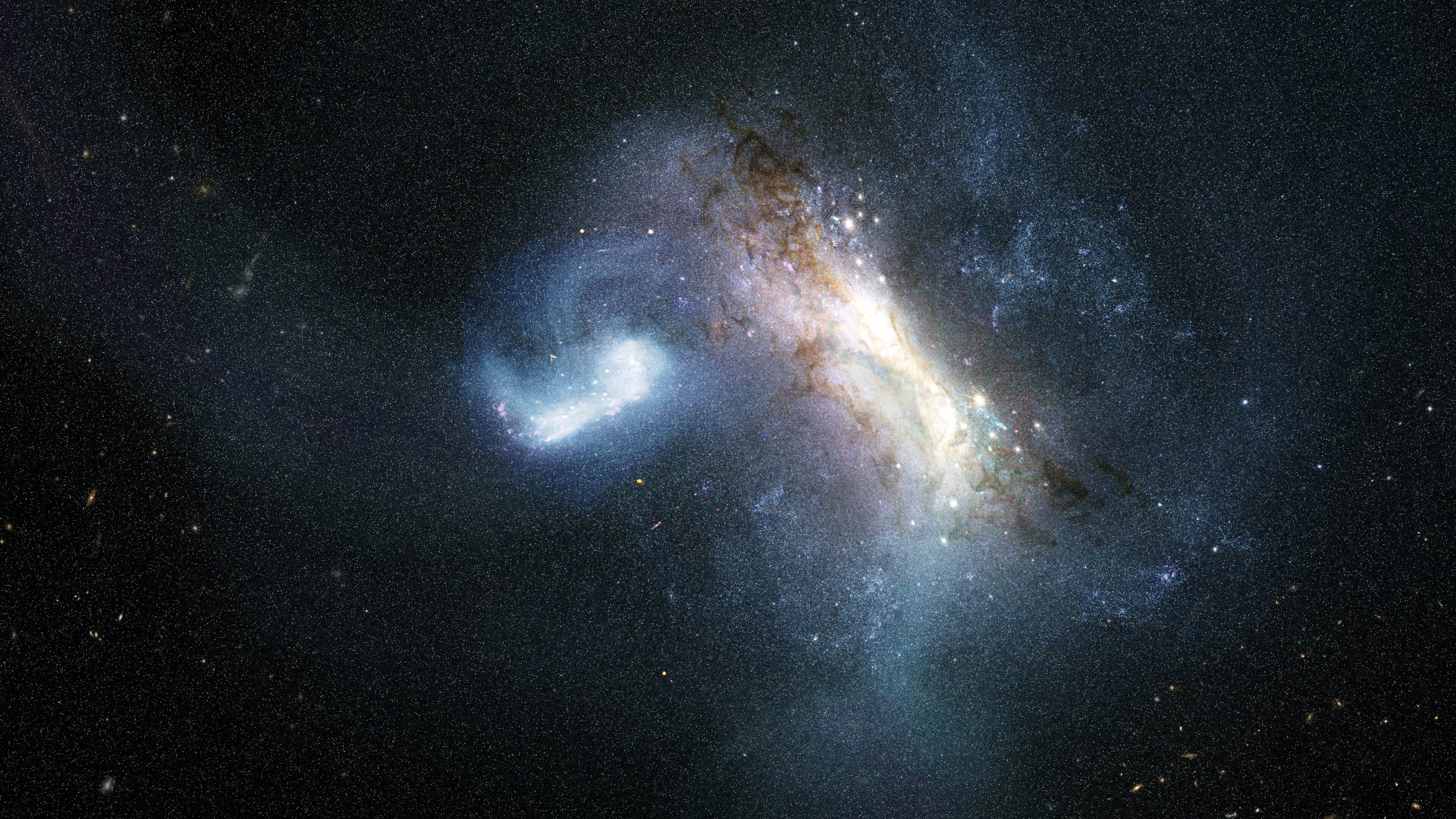 Artist's concept of a dwarf galaxy colliding and merging with the Milky Way, showing swirling gas, dust lanes, and bright stellar clusters against a star-filled background.