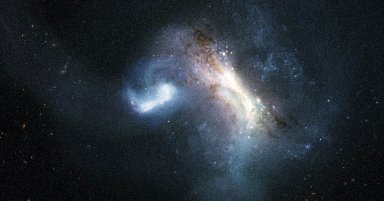 Artist's illustration of two galaxies colliding in deep space, with a bright elongated galaxy and a smaller luminous mass merging against a star-filled cosmic backdrop.