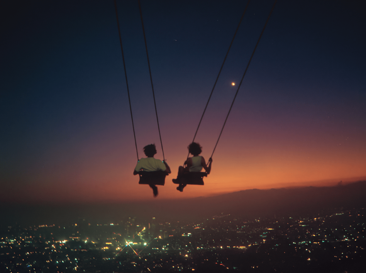 Illustration of two people on swings above a city at sunset.