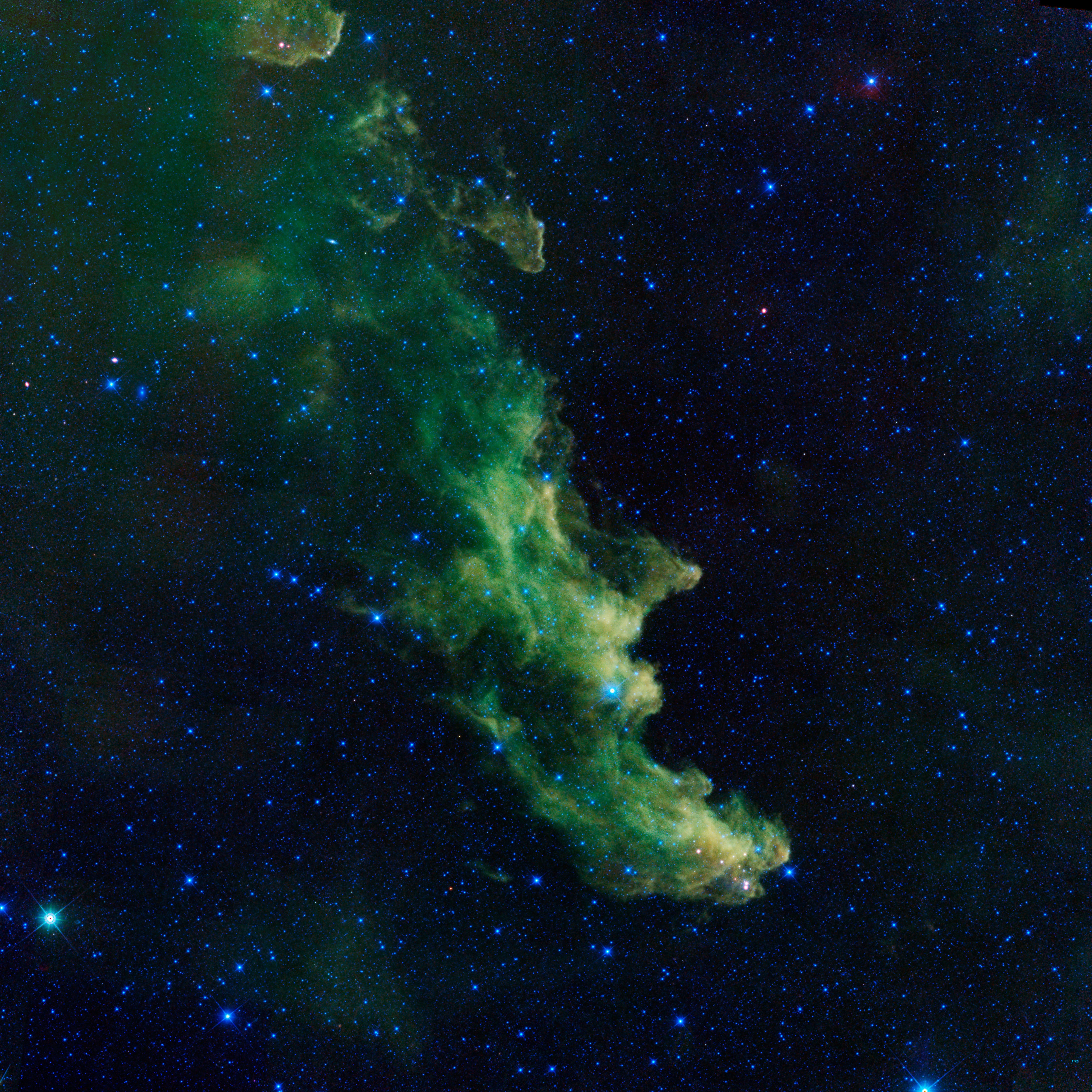 Infrared image of the Witch Head Nebula showing green glowing gas and dust clouds against a star-filled black sky.